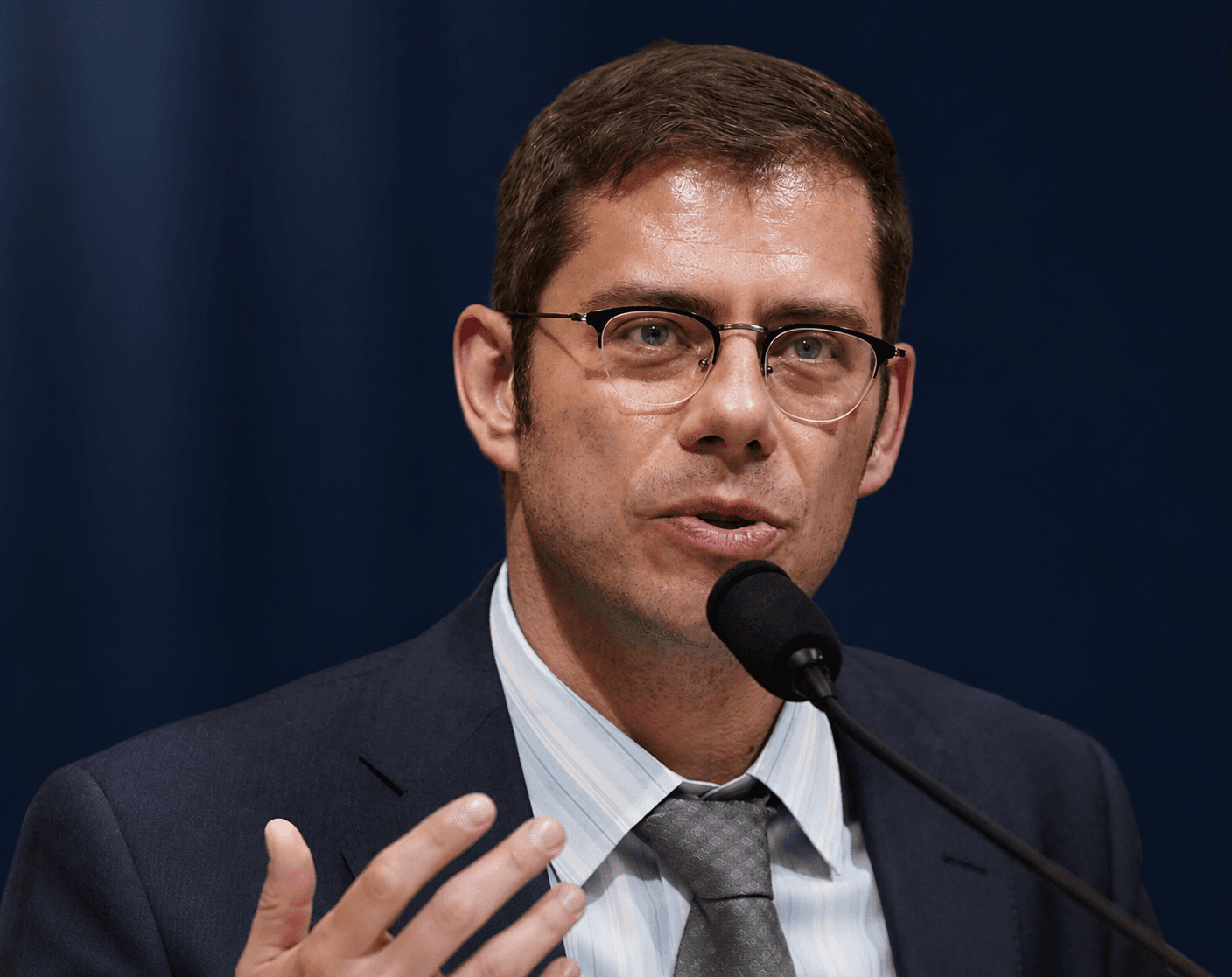 Professor Eugene Kontorovich speaking at a microphone